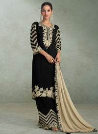Three‑piece black and gold salwar suit with embroidered kameez, wide‑leg salwar, and beige dupatta