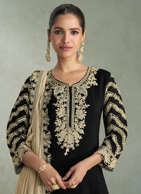Beige dupatta with gold embroidered border paired with black salwar suit